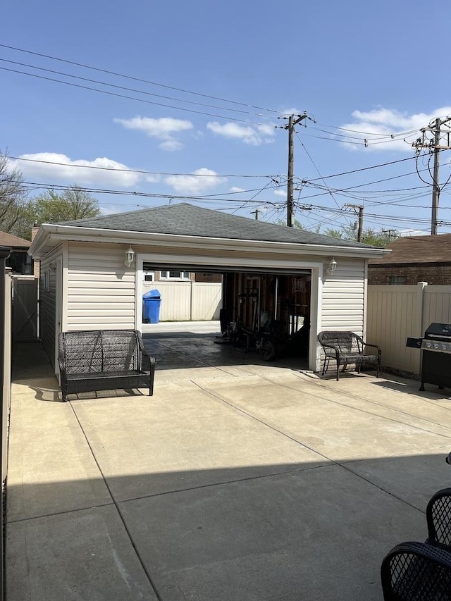 detached garage featuring fence