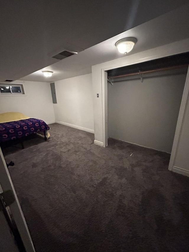 bedroom featuring baseboards, dark colored carpet, and visible vents