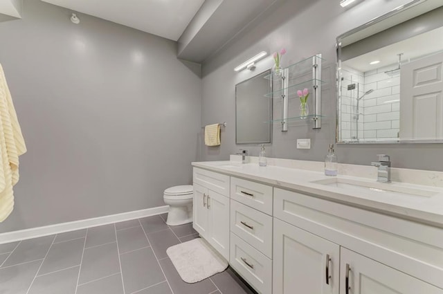 1111 S State St Unit A500, Chicago, IL 60605 - full bathroom featuring double vanity, tile patterned flooring, a tile shower, a sink, and baseboards
