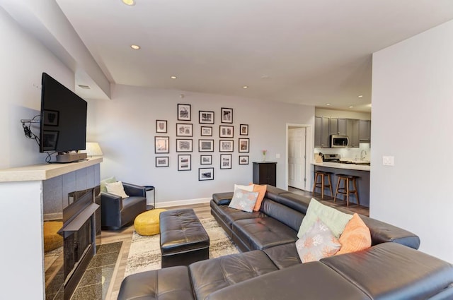 1111 S State St Unit A500, Chicago, IL 60605 - living room featuring recessed lighting, baseboards, a tiled fireplace, and wood finished floors
