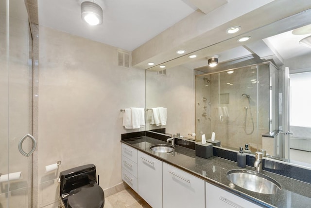 bathroom featuring visible vents, a sink, a stall shower, and double vanity