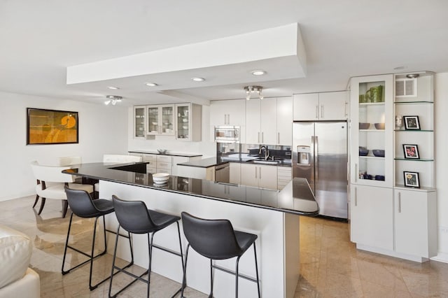 505 N Lake Shore Dr Unit 4412, Chicago, IL 60611 - kitchen with appliances with stainless steel finishes, a sink, a breakfast bar area, dark countertops, and recessed lighting