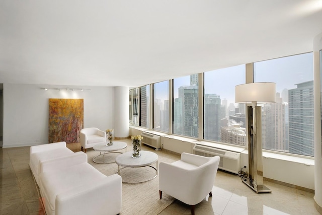 living area with baseboards, a city view, and light tile patterned flooring