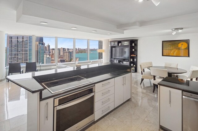 505 N Lake Shore Dr Unit 4412, Chicago, IL 60611 - kitchen with stainless steel appliances, dark countertops, open floor plan, white cabinets, and recessed lighting