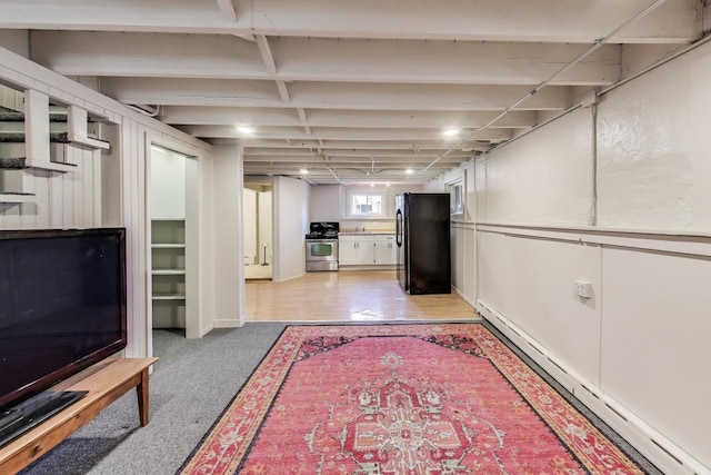 360 W Maple St, Lombard, IL 60148 - basement featuring freestanding refrigerator, a baseboard heating unit, and light carpet