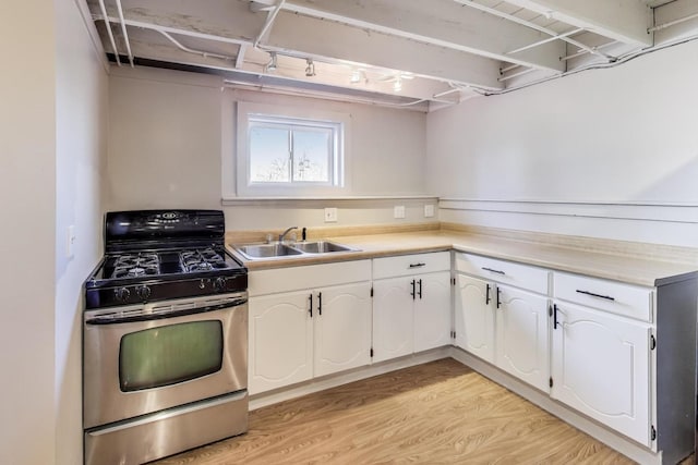 360 W Maple St, Lombard, IL 60148 - kitchen featuring stainless steel gas stove, a sink, light countertops, light wood finished floors, and white cabinetry