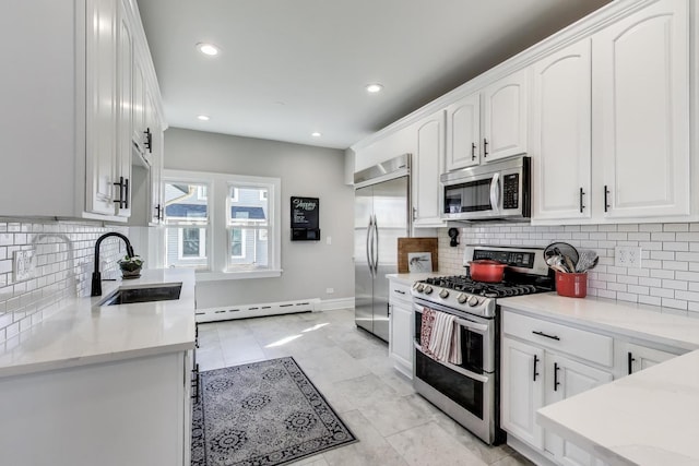 360 W Maple St, Lombard, IL 60148 - kitchen featuring white cabinets, a sink, stainless steel appliances, a baseboard radiator, and backsplash