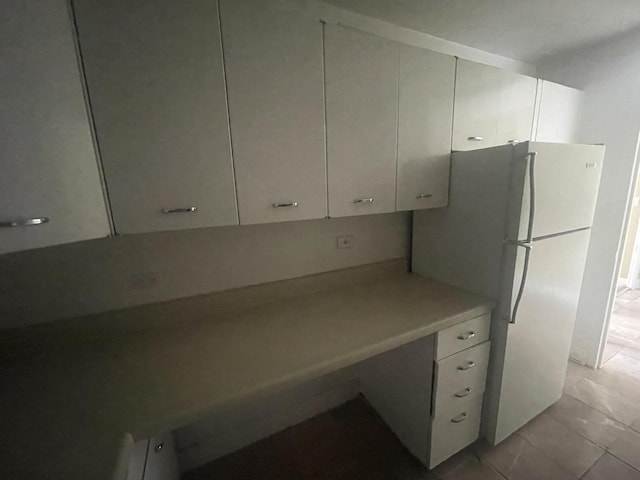 4800 S Chicago Beach Dr Unit 2614N, Chicago, IL 60615 - kitchen with freestanding refrigerator, light countertops, white cabinets, and light tile patterned flooring