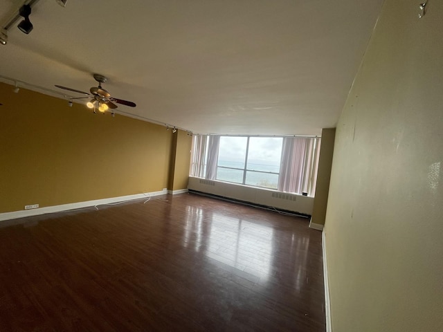 4800 S Chicago Beach Dr Unit 2614N, Chicago, IL 60615 - spare room with a baseboard heating unit, wood finished floors, ceiling fan, rail lighting, and baseboards