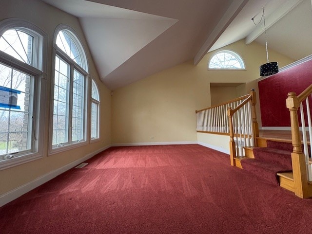 additional living space with carpet flooring, beam ceiling, high vaulted ceiling, stairs, and baseboards