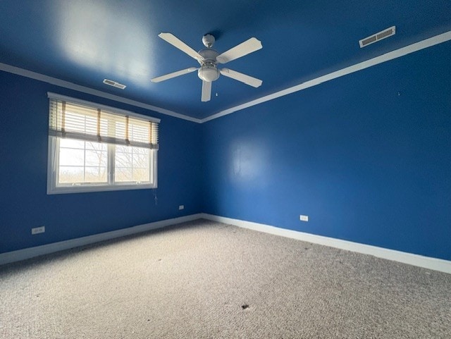 spare room with visible vents, carpet, and baseboards