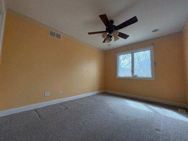 empty room featuring visible vents, baseboards, carpet floors, and ceiling fan