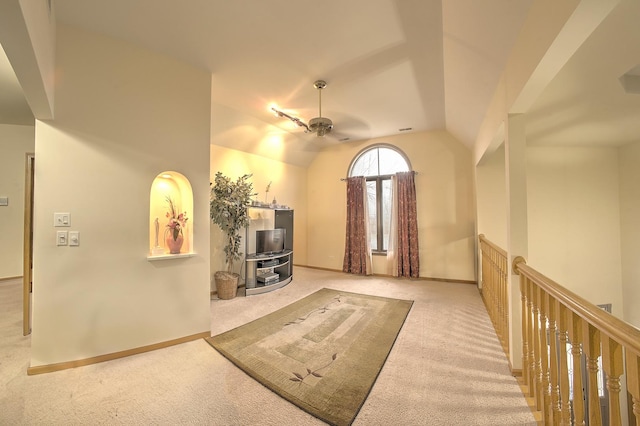 interior space featuring baseboards, a ceiling fan, carpet, and lofted ceiling