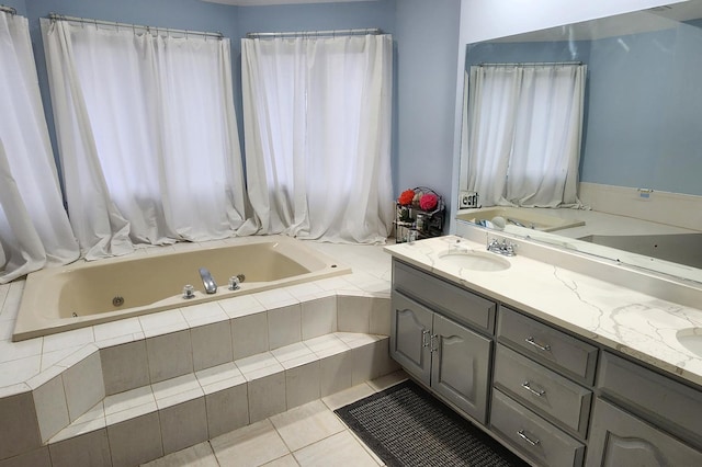 bathroom with a sink, tile patterned floors, a jetted tub, and double vanity