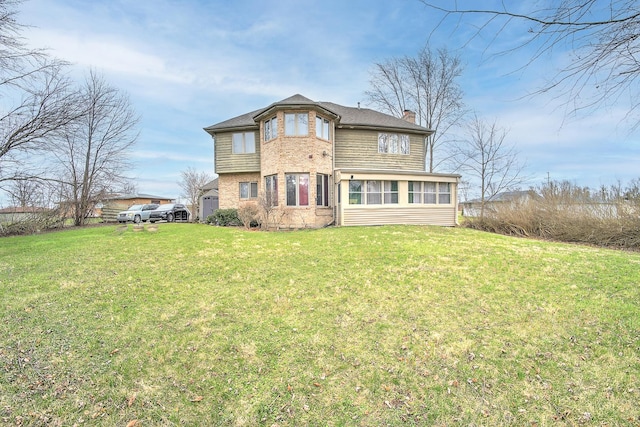 back of property with a yard and a chimney