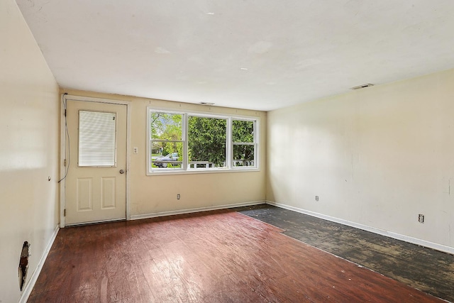 spare room with hardwood / wood-style flooring and baseboards