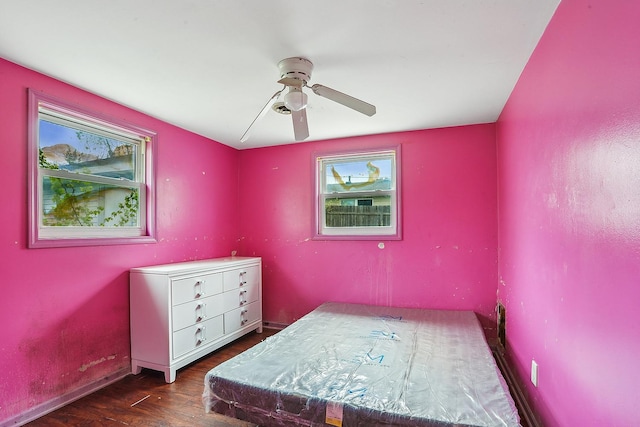 bedroom with wood finished floors, ceiling fan, and baseboards