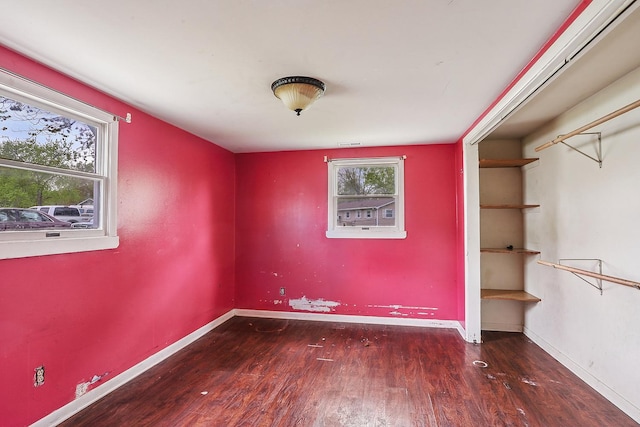 unfurnished room featuring wood finished floors and baseboards