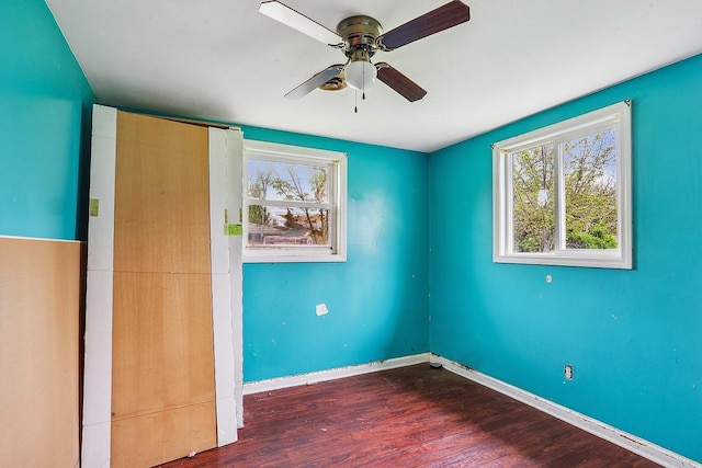 unfurnished bedroom with wood finished floors, baseboards, and ceiling fan