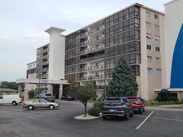 view of property featuring uncovered parking