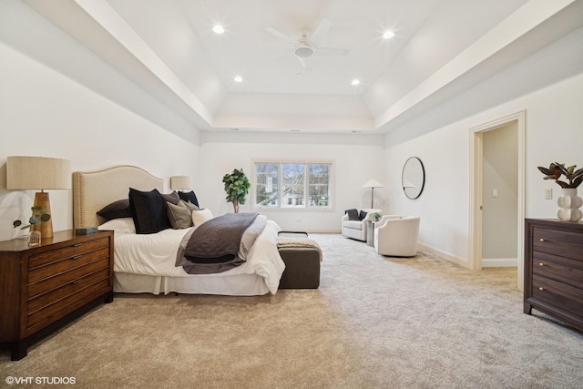 bedroom featuring a ceiling fan, baseboards, recessed lighting, a tray ceiling, and carpet flooring