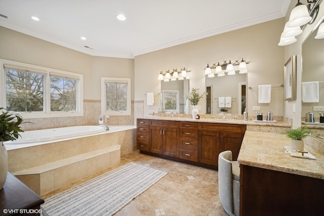 bathroom featuring crown molding, double vanity, a bath, and a sink
