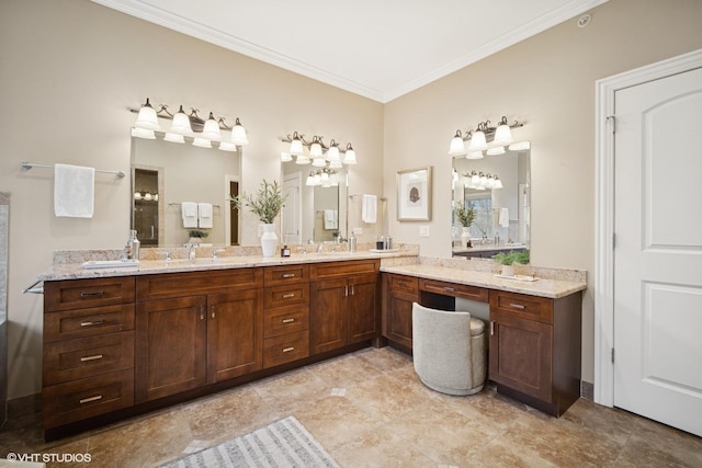 bathroom featuring crown molding, double vanity, and a sink