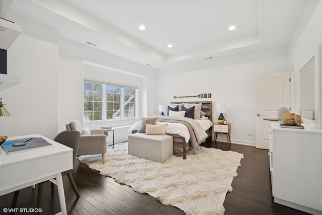 bedroom with recessed lighting, visible vents, dark wood-style floors, and a raised ceiling