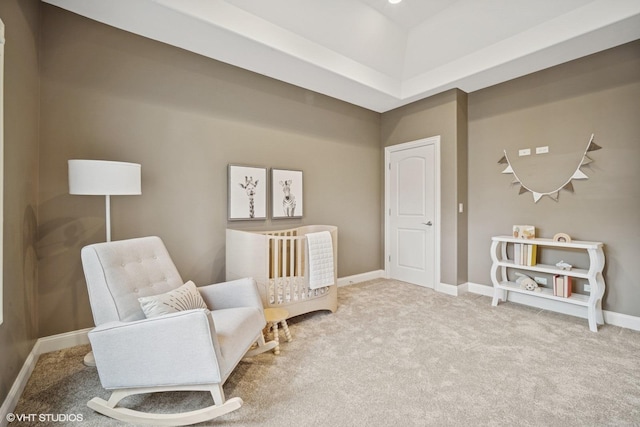 sitting room featuring baseboards and carpet