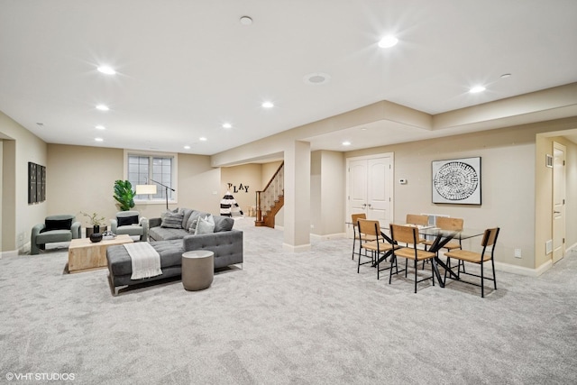 carpeted living room featuring baseboards, recessed lighting, and stairs