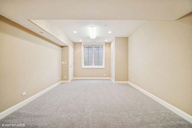 basement with baseboards and light carpet