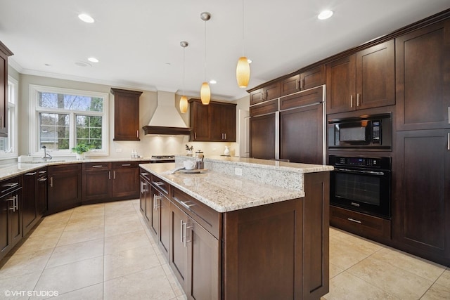 kitchen with ornamental molding, light tile patterned flooring, premium range hood, a center island, and black appliances