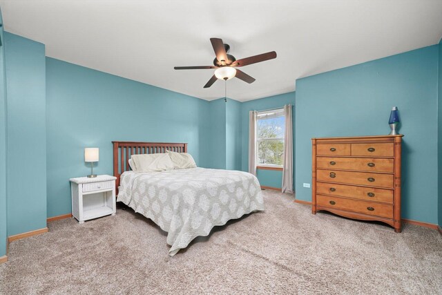 carpeted bedroom with baseboards and ceiling fan
