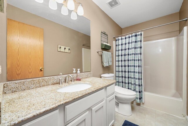 bathroom featuring visible vents, vanity, toilet, tile patterned floors, and shower / tub combo