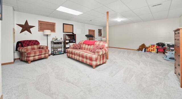 carpeted living room with baseboards, a drop ceiling, and visible vents
