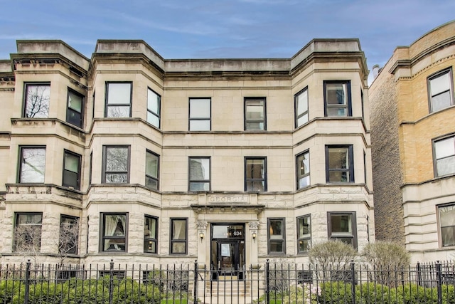 view of building exterior with a fenced front yard