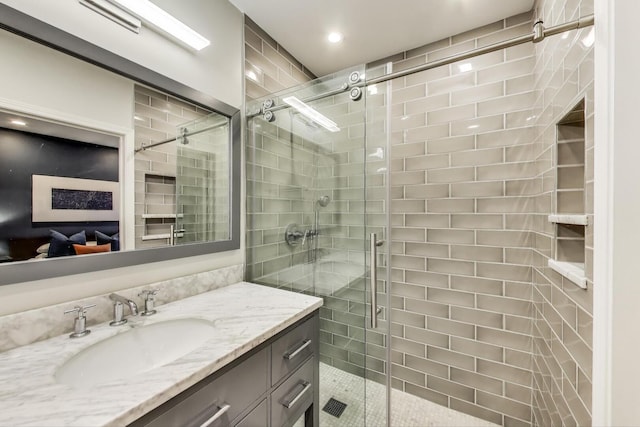 bathroom featuring vanity, recessed lighting, and a shower stall