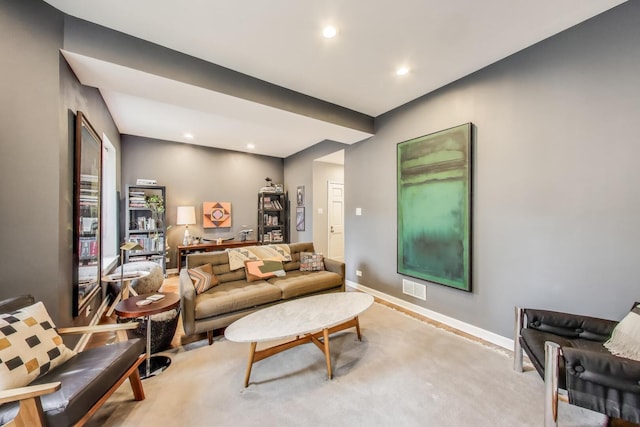 living room with visible vents, recessed lighting, baseboards, and light colored carpet