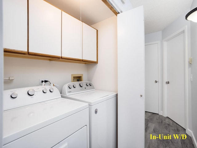 clothes washing area with separate washer and dryer, cabinet space, and light wood-style floors