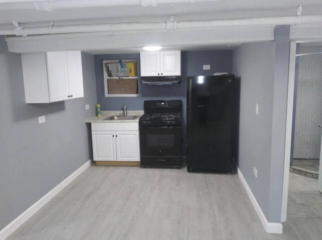 kitchen featuring a sink, black appliances, white cabinetry, and under cabinet range hood