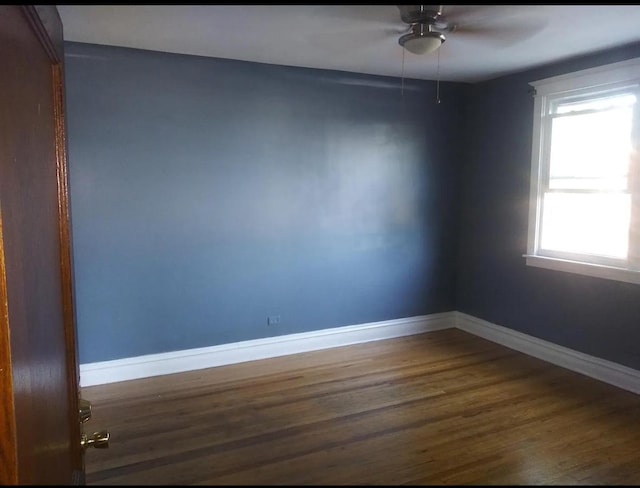 spare room with baseboards, a ceiling fan, and wood finished floors