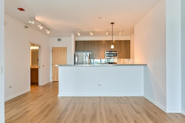125 S Green St Unit 1007A, Chicago, IL 60607 - kitchen with stainless steel appliances, light wood-style floors, track lighting, and a peninsula
