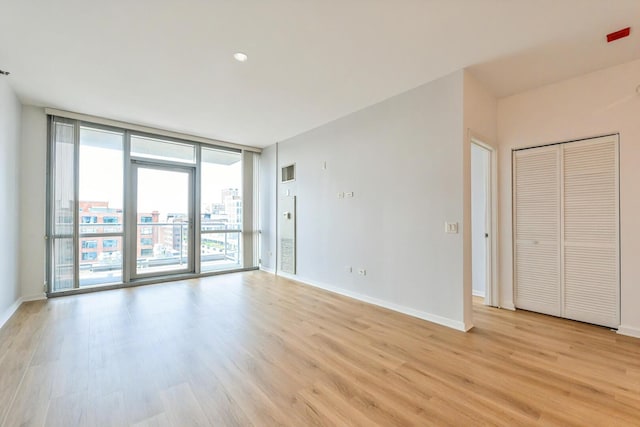 125 S Green St Unit 1007A, Chicago, IL 60607 - spare room featuring floor to ceiling windows, light wood finished floors, and baseboards