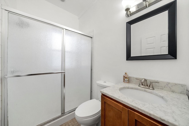 bathroom featuring vanity, a shower stall, and toilet