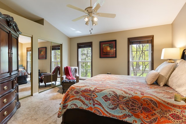 bedroom featuring a ceiling fan, lofted ceiling, light carpet, and multiple windows