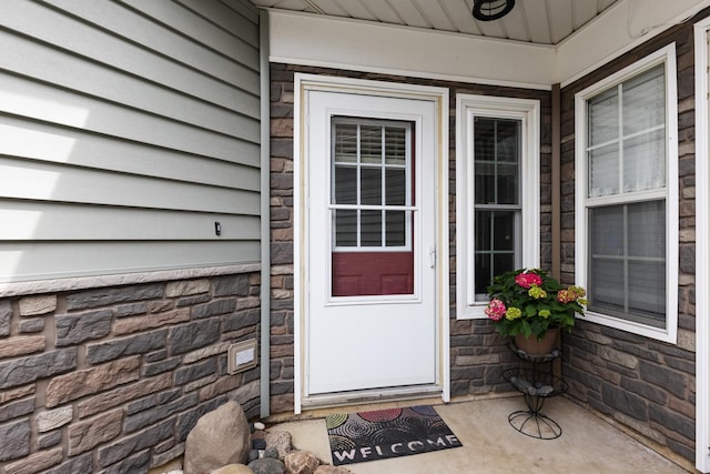 doorway to property featuring stone siding