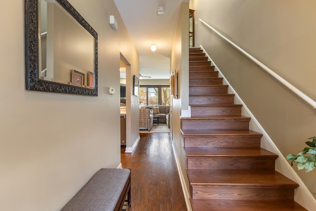 stairway featuring baseboards and wood finished floors