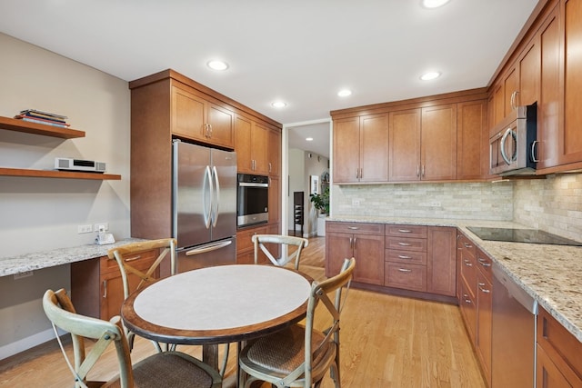 1150 Park Ave W, Highland Park, IL 60035 - kitchen with appliances with stainless steel finishes, brown cabinets, light wood-type flooring, and recessed lighting