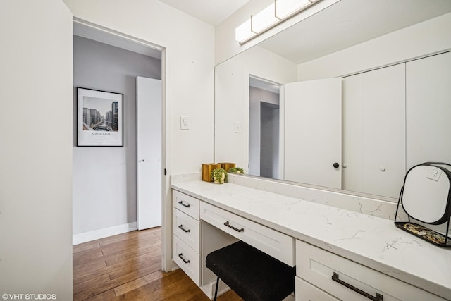 bathroom with wood-type flooring and baseboards