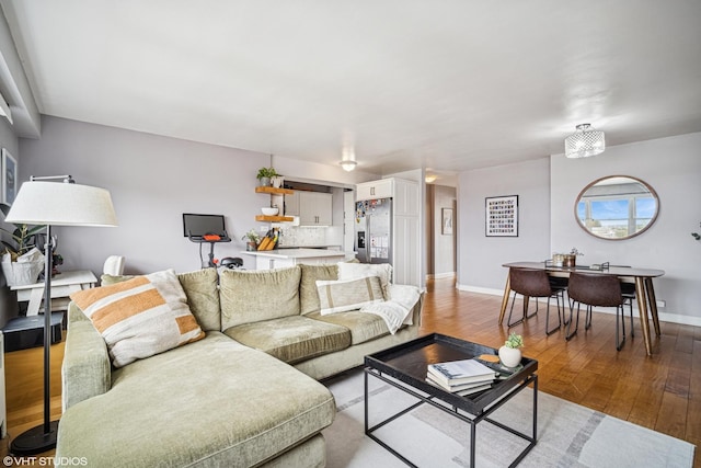 living area with baseboards and light wood-type flooring
